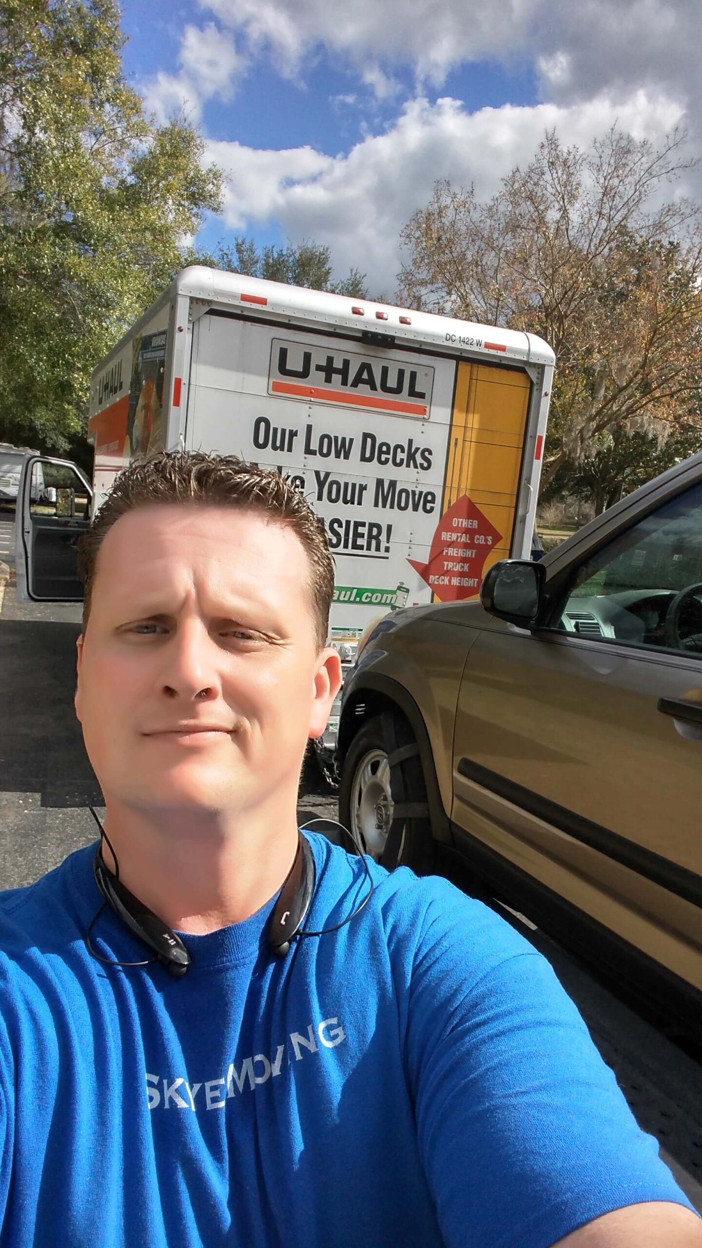 An image of Skye Moving LLC worker in front of the moving truck.