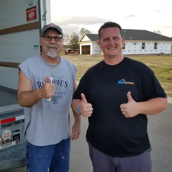 James Gervais, the owner of Skye ?Moving, with a satisfied client in Jacksonville, FL